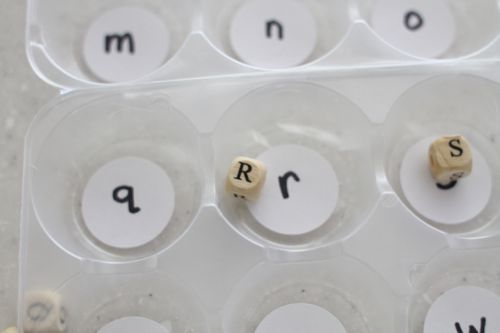 alphabet-bead-sorts A divided container with letters written in each compartment with corresponding beads in a few as an example of alphabet activities