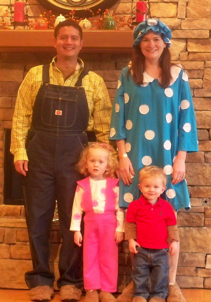 Berenstain Bears A family is dressed up, the father is wearing overalls and a yellow shirt, the mother is wearing a blue and white polka dot dress, the daughter is in pink overalls, and the little boy is in jeans and a red shirt.