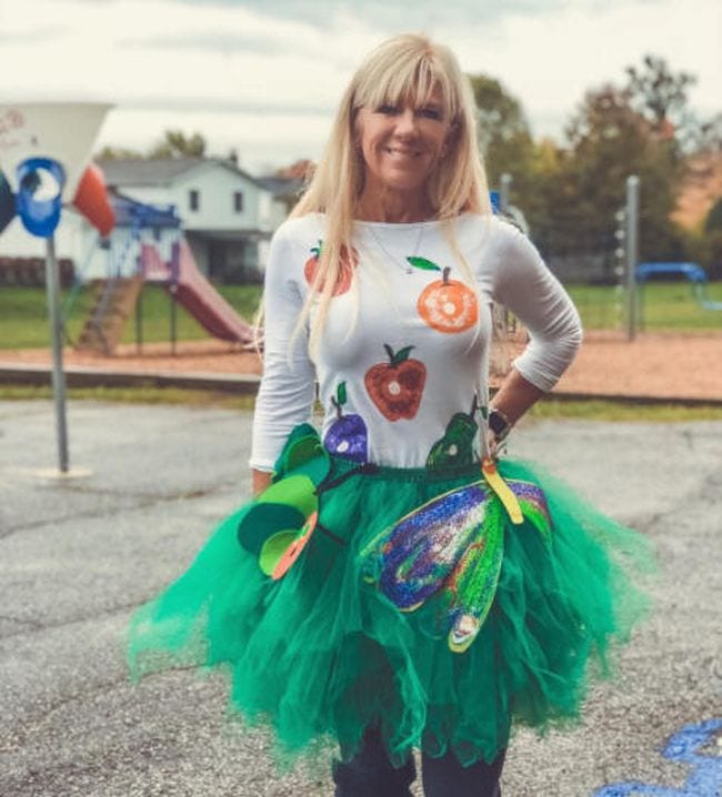 Book Character Costume Ideas Very Hungry Caterpillar Woman wearing a green tutu and white shirt covered with pictures of food (Book Character Costume Ideas)