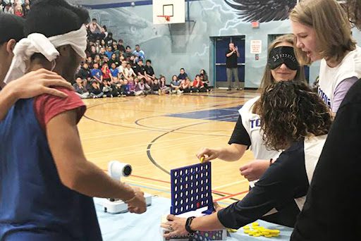 Connect 4 Students playing Connect 4 while being blindfolded in this example of pep rally activities