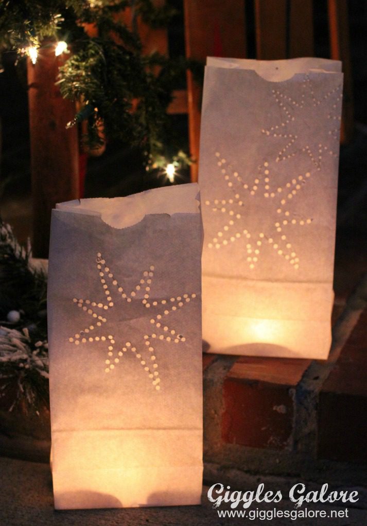 Glowing paper bag luminaries with pine tree, as an example of Hispanic Heritage Month activities.