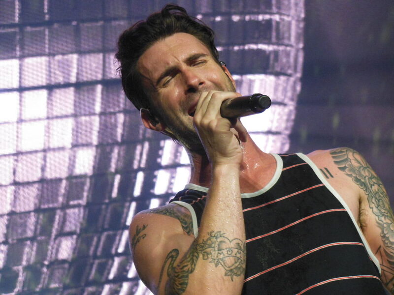 Famous People with ADHD Adam Levine on stage singing