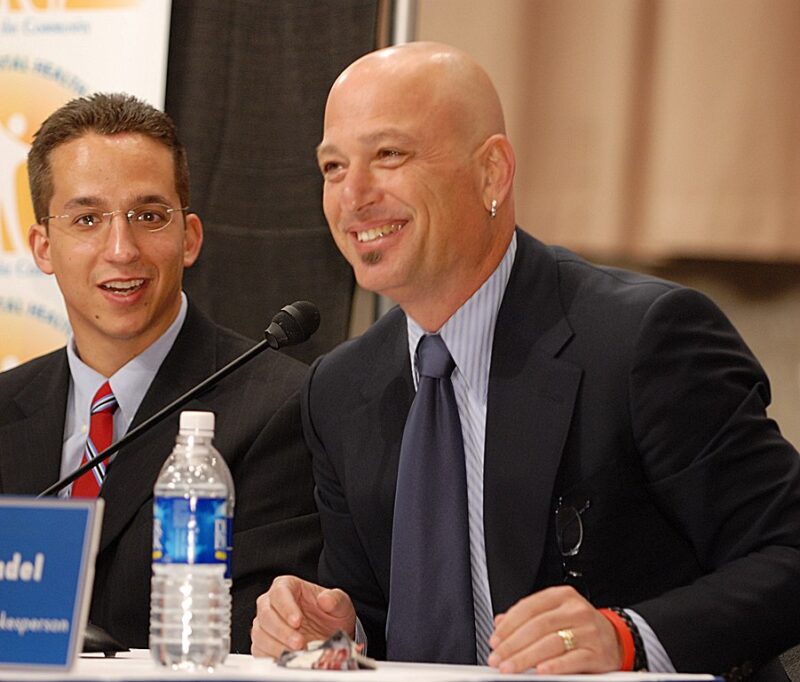 Famous People with ADHD Howie Mandel sitting at a table and speaking on a panel