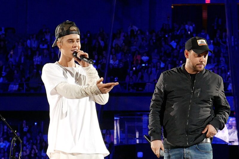 Famous People with ADHD Justin Bieber on stage with Scooter Braun