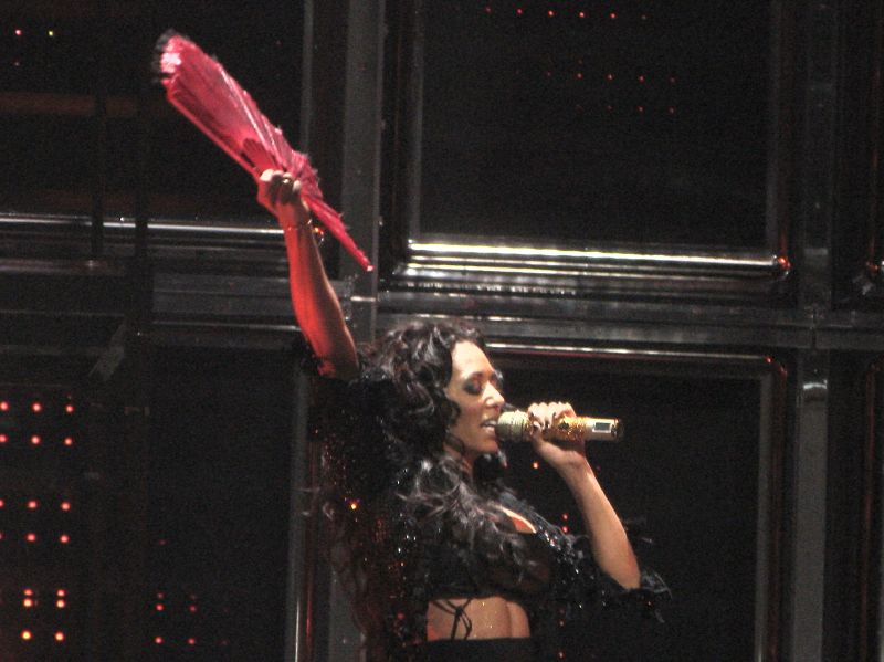 Famous People with ADHD Mel B, otherwise known as Scary Spice, on stage with a red fan