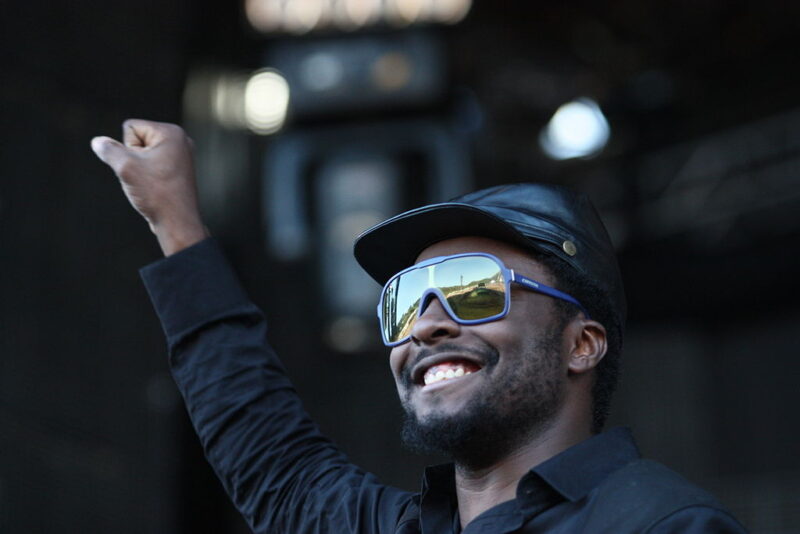 Famous People with ADHD will.i.am wearing sunglasses and a black cap and shirt
