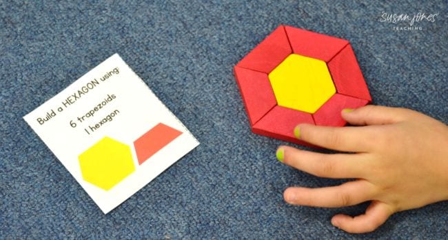 First grade math student putting together hexagon and trapezoid blocks to make a new shape