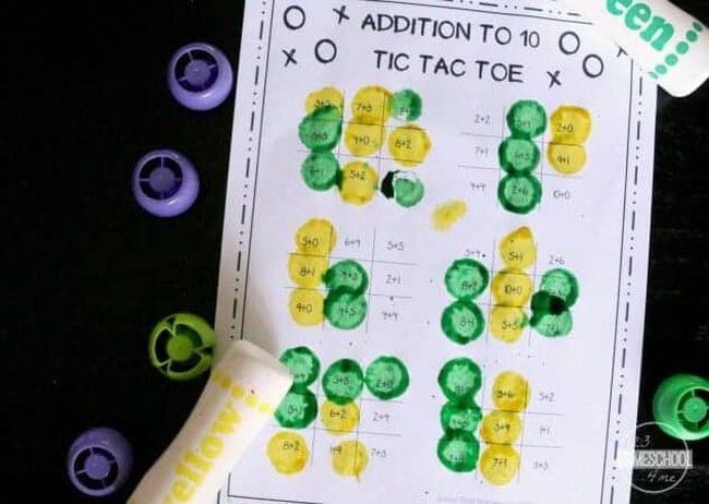 Tic-tac-toe boards with addition problems, filled in using bingo daubers