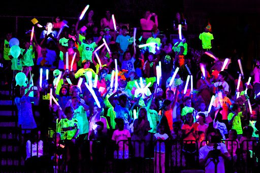 Glow Party Students in a black-lit room wearing neon clothing