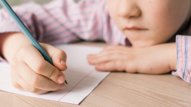 Close-up of student writing a letter