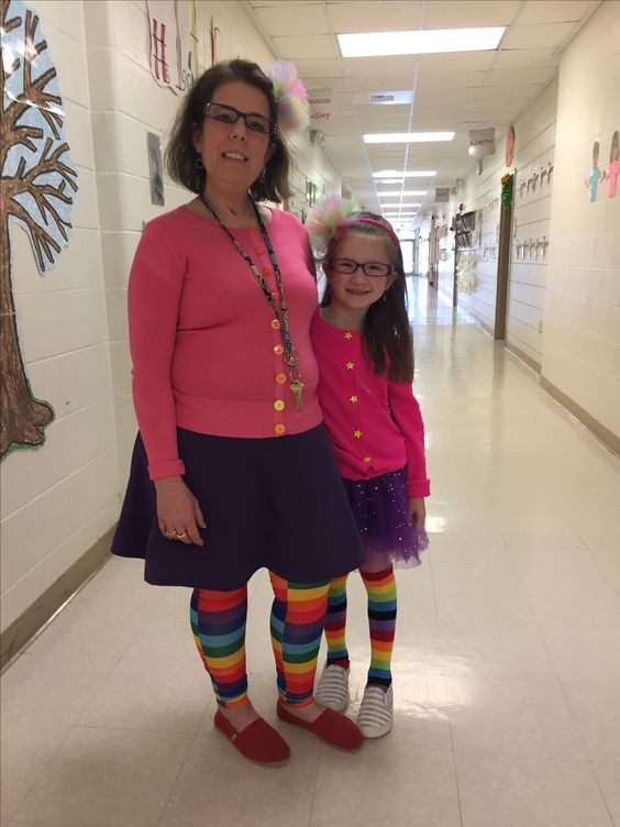 Junie B. Jones A teacher and a little girl are wearing matching outfits that include a hot pink cardigan, purple skirts, and rainbow knee highs.