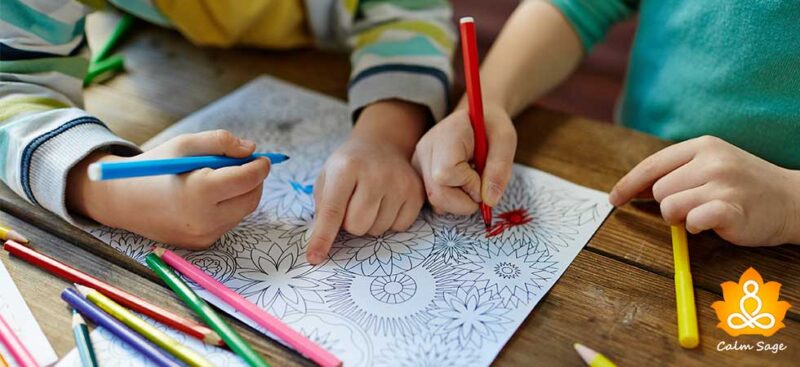 Mandalas Two children sit at desks and color a mandala with colored pencils