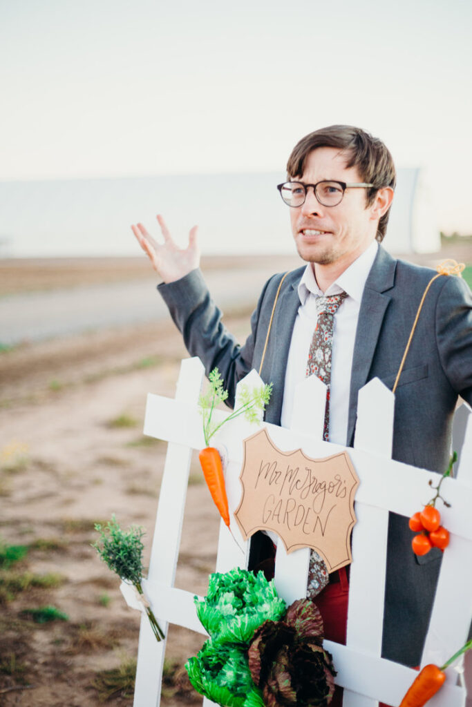 Mr. McGregor’s Garden A man in a suit has a white picket fence hanging off of him and vegetables.- book character costume