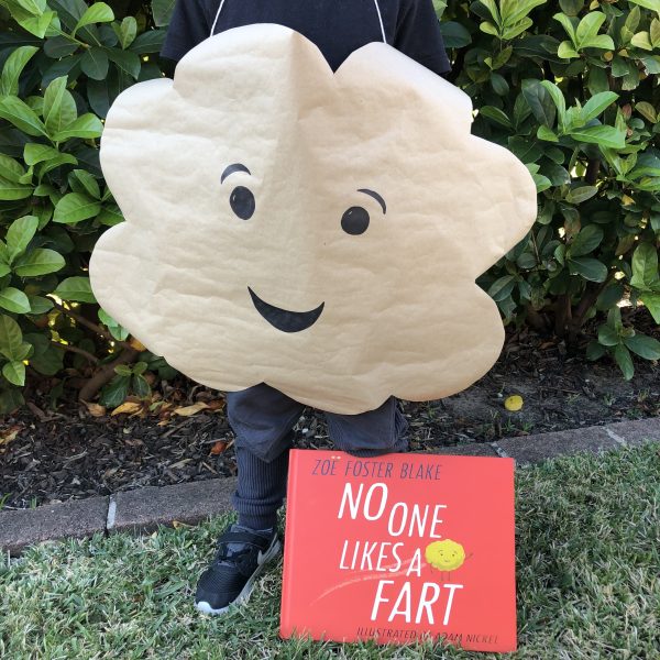 No One Likes a Fart A cloud shape is cut out with a smiley face drawn on it and hung over someone's neck. The book No One Likes a Fart is also shown.