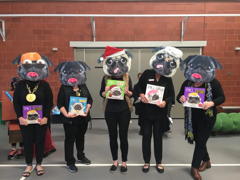 Pig the Pug Five teachers are shown wearing pug masks and holding different Pig the Pug books.
