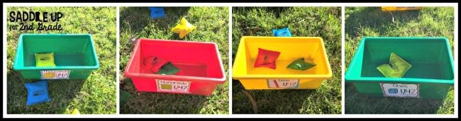 Colorful plastic bins labeled with tens, hundreds, and thousands with bean bags in each