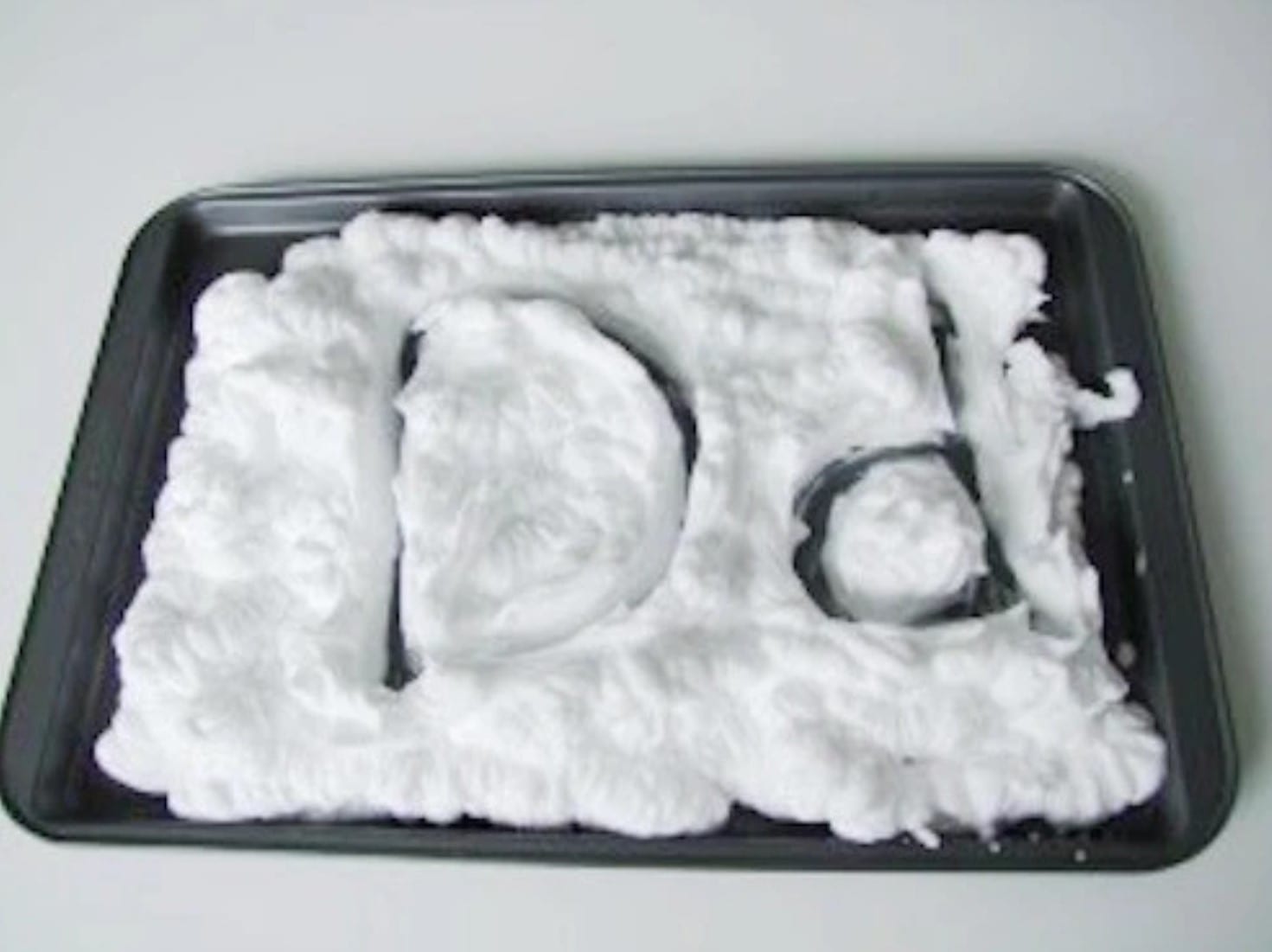 shaving cream Upper case and lower case letter D written on a cookie sheet covered with shaving cream