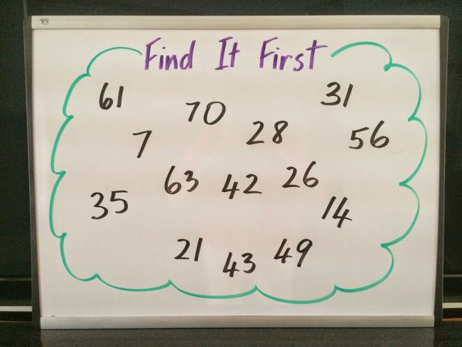 multiplication-find-it-first Random numbers written on a whiteboard, labeled "Find It First" as an example of how to teach multiplication