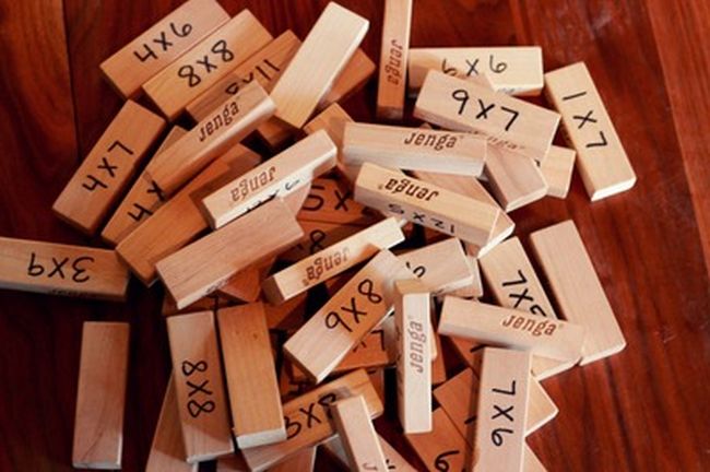 multiplication-jenga A jumble of Jenga wooden blocks with multiplication facts written on them used to teach multiplication