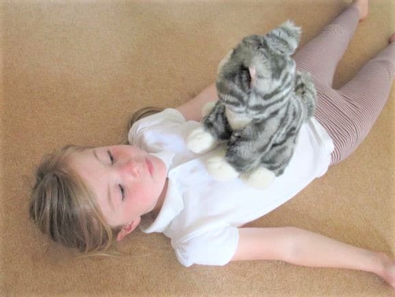Teddy Breathing A young student lies on the floor with a stuffed animal on her chest