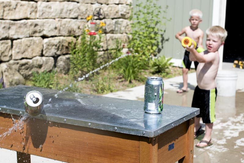 Boy playing with water gun- summer activities for kids