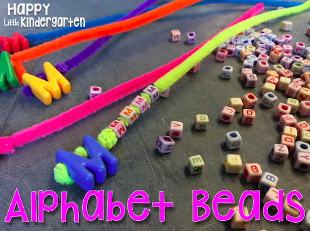 alphabet-beads Colorful pipe cleaners strung with a large "M" bead beside smaller alphabet bead on a table as an example of alphabet activities