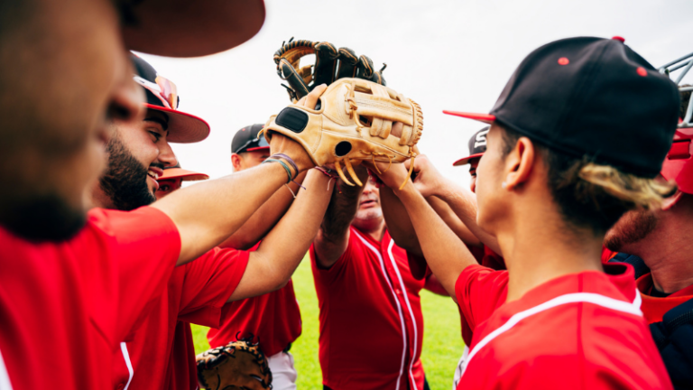 Baseball team high-fiving with gloves