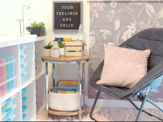 Calm Down Corner calm down spot in classroom with a comfy chair and cart with calming activities